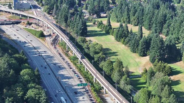 medium zoomed aerial of light rail train heading south to Seattle