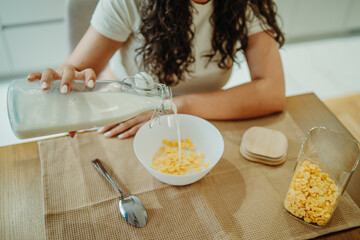 Young caucasian woman eating cereals for breakfast at home	
