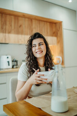 Young caucasian woman eating cereals for breakfast at home	