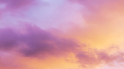 Obraz premium Dramatic sunrise with gradient orange and purple clouds, creating a panoramic abstract sky view. 
