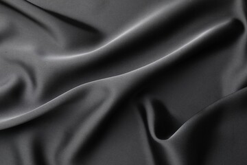 Fototapeta premium Crumpled black silk fabric as background, top view