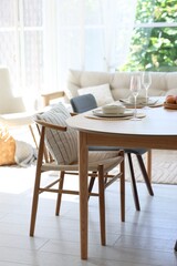 Naklejka na ściany i meble Beautiful table setting, chairs and decor in dining room. Interior design