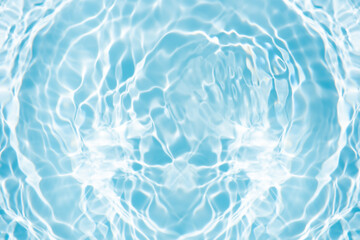 Blue water with ripples on the surface. Defocus blurred transparent blue colored clear calm water surface texture with splashes and bubbles. Water waves with shining pattern texture background.