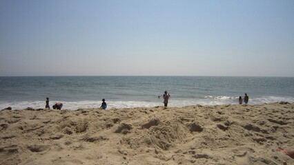 people walking on the beach