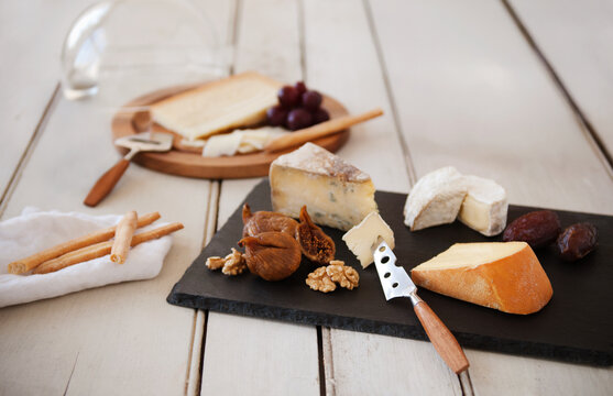 Assorted gourmet cheeses with fruit and nuts - Powered by Adobe