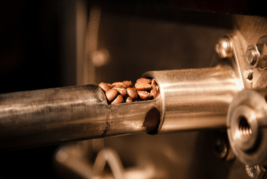 Coffee beans being roasted in a commercial coffee roaster