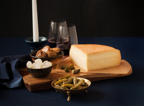 Raclette cheese with gherkins, pearl onions and red wine