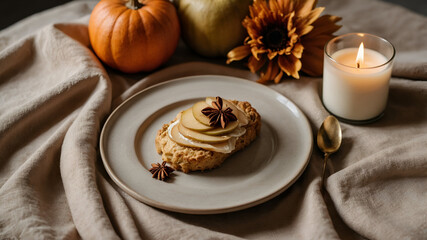 Autumn Still Life: Pear toast, pumpkin, sunflower, and candle create a cozy, seasonal atmosphere.