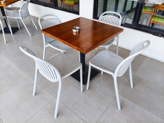 wooden table and white metal chairs in a restaurant