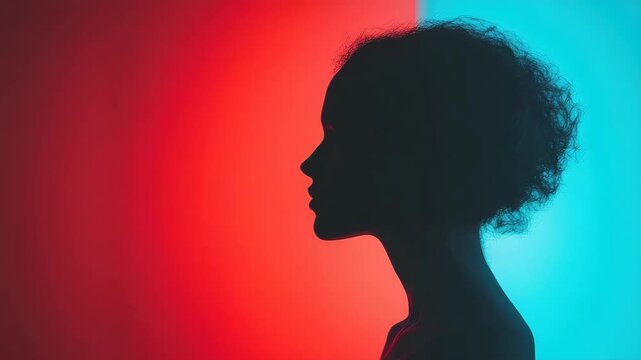 Silhouette of person against blue and red split background