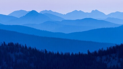 Mountain landscape bathed in twilight hues of deep blue and fading sunset colors.
