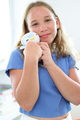 portrait of pretty young teenage girl with brown  hair holding teddy bear