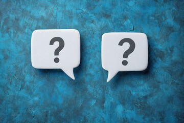 Two white speech bubbles with question marks on textured blue background symbolizing confusion or inquiry