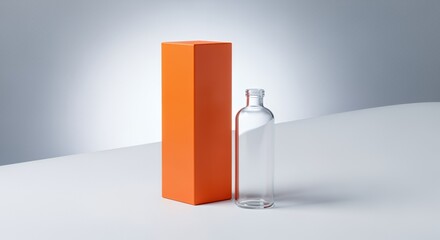 A simple, elegant glass bottle rests beside a vibrant orange box on a minimalist white , creating a clean and modern product display.