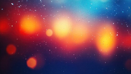 Fototapeta premium Raindrops scattered on a windowpane with blurred warm and cool bokeh lights in the background creating a tranquil and dreamy atmosphere