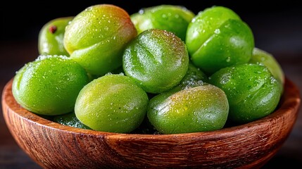 Fresh green plums in wooden bowl