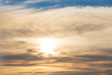 Fototapeta premium Warm Evening Light Filtering Through Soft Clouds.