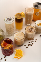 A row of autumn-themed drinks, featuring mulled wine, popcorn latte, and lavender coffee on a light backdrop