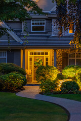 Entrance of luxury house with nice green Summer landscape at night in Vancouver, Canada, North America. July 2025.