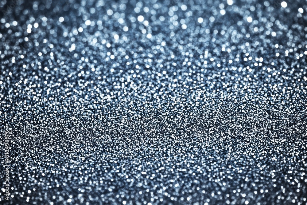 Poster close-up of shimmering silver glitter spread evenly with sparkling light reflections creating a fest