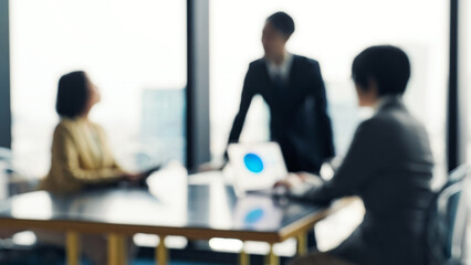 Blurred image of a group of business people having a meeting in an office