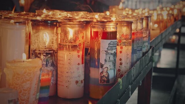 Visitors to the Temple offer candles to the Black Christ for miracles. Prayer center. Take Close-up.