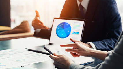 A group of business people having a meeting in an office while looking at a screen