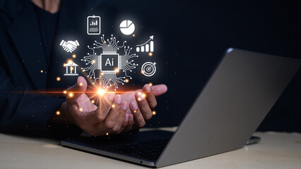 A person holding glowing AI technology icons above their hands, symbolizing artificial intelligence and data analytics with a laptop in the background.