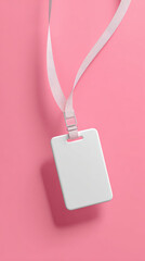 Blank ID card hanging from lanyard on pink background, creating clean and modern look. This evokes sense of simplicity and organization