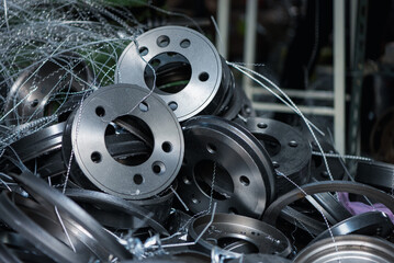 Car mechanic or serviceman disassembly and checking a disc brake and asbestos brake pads for fix...