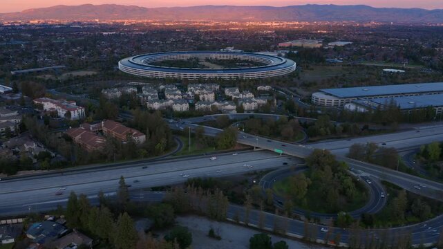 Aerial view of Apple Park headquarters at sunset. The circular building is a landmark of Silicon Valley.  Cupertino, California, USA.