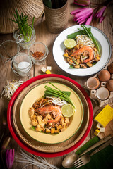 Pad Thai Pad Thai with rice vermicelli and shrimp with ingredients placed on the table., top views