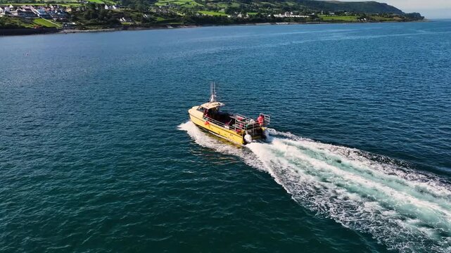Aerial View of a fishing boat working in Carnlough Bay and harbour at Glencloy by the Irish Sea Co Antrim Northern Ireland 27-07-25