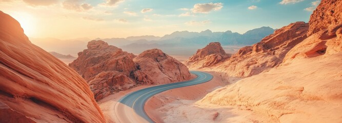 Dusty highway winds through rugged terrain under a vibrant sunset in the desert landscape