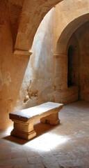 Stone bench basks in sunlight filtering through arched openings in a textured, sun-baked room. Shadows and light play on the walls and floor, creating a serene atmosphere