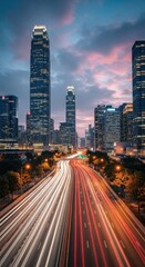 Fototapeta premium Modern Cityscape With Streaking Headlights On Highway At Dusk