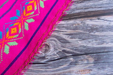 Top view of part of a table with a fabric with Mexican geometric embroidered prints of various...