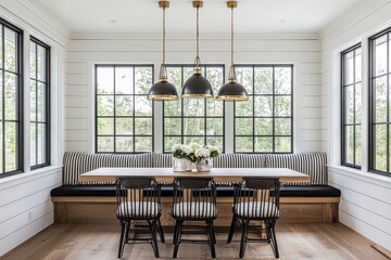 Black and white modern farmhouse dining room with gold pendant lights, oak flooring, striped linen bench, and large windows with natural light