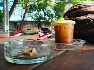 Close-Up of Used Cigarettes in Glass Ashtray