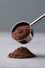 Nutritional Supplement Preparation, A metal scoop pouring a serving of chocolate protein powder onto a gray surface.