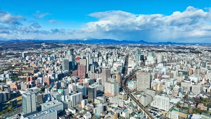 Fotobehang 青空の現代都市のドローン空撮 © metamorworks