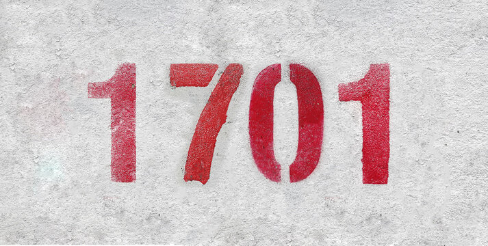 Red Number 1701 on the white wall. Spray paint.