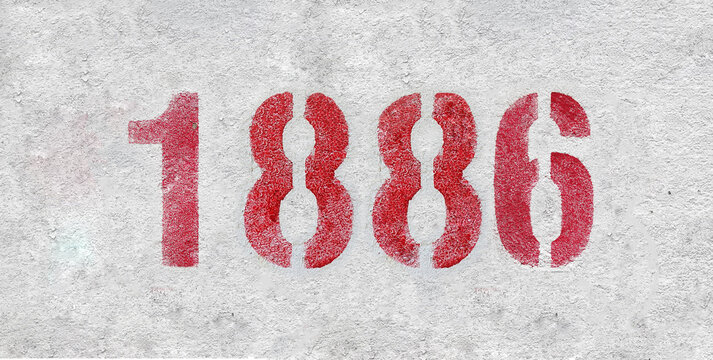 red spray-painted number 1886 sprayed onto a white wall.