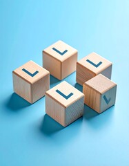 Fototapeta premium Five light-wood blocks, each with a blue 'L', form a cluster on a light-blue background; one block shows a checkmark