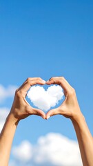 Hands forming heart shape around cloud