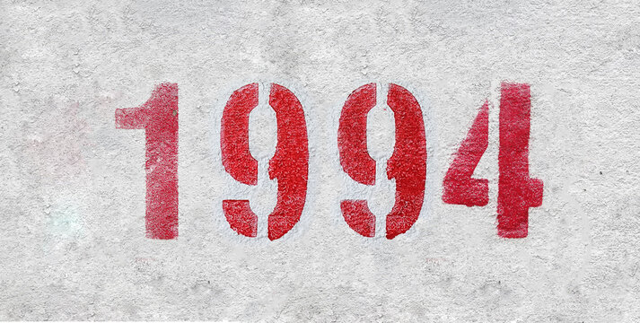 red spray-painted number 1994 sprayed onto a white wall.