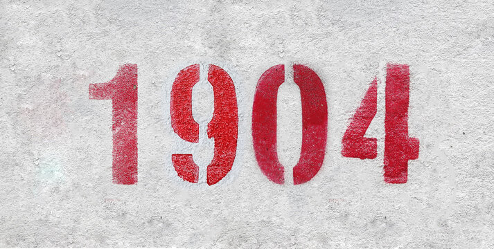 red spray-painted number 1904 sprayed onto a white wall.