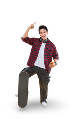 A young man pointing upwards, standing next to his skateboard while holding a phone on png...