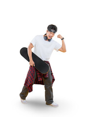 A young man showing strength, holding a skateboard, with headphones on and with a bright expression...