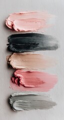 Smears of blush, grey, beige, rose, and silver paint arranged vertically on a textured surface. Brushstrokes blend color gradients with rough, artistic strokes